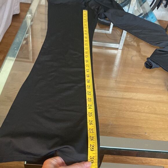 Put on black flare pants with cut out waste accent and silver accessory. Stretch - Picture 6 of 11